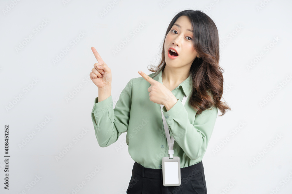 Portrait of the beautiful Asian businesswoman pointing up with both hands