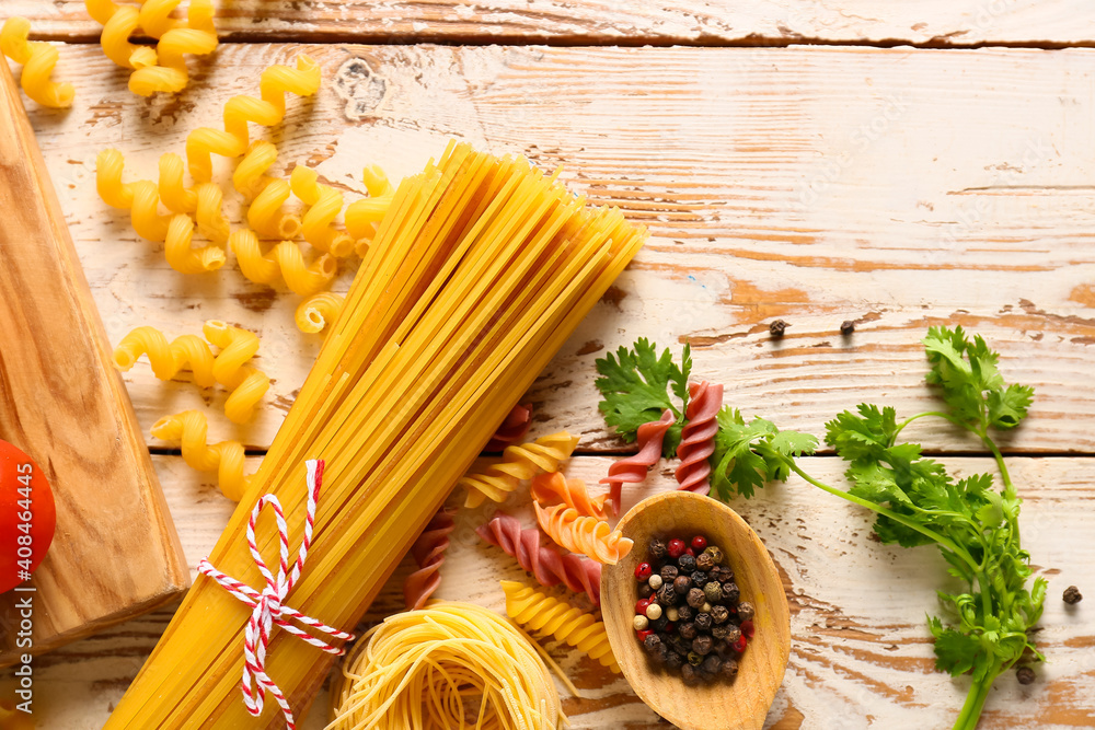 Assortment of dry pasta and spices on table