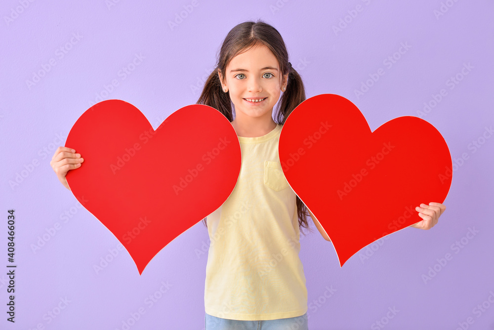 Cute little girl with red hearts on color background