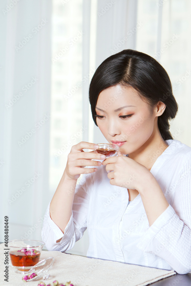 The young woman drinking tea