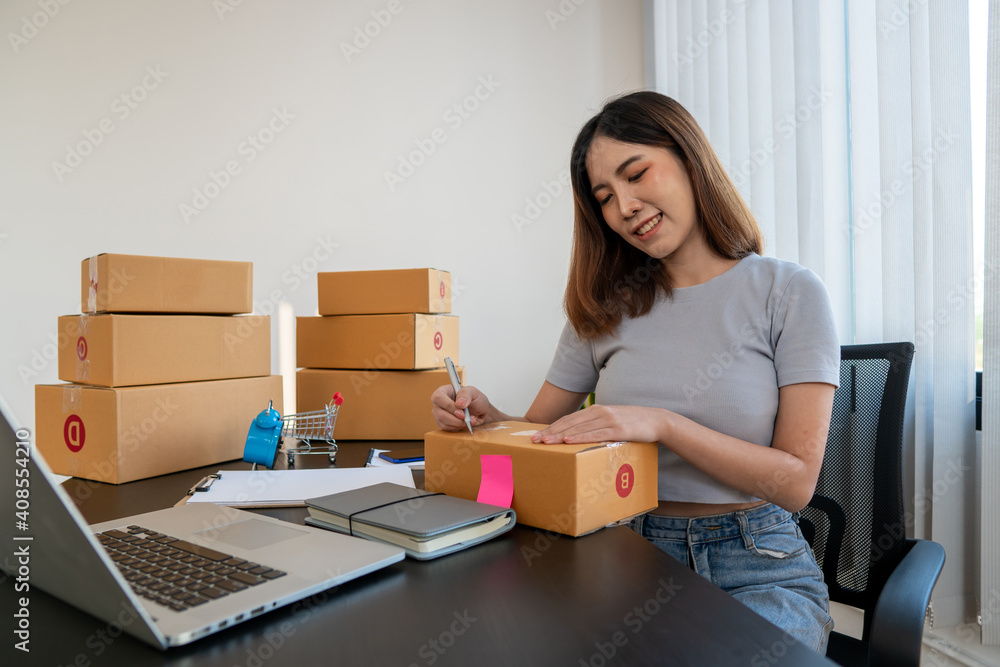 Starting small businesses SME owners female entrepreneurs check online orders to prepare to pack the