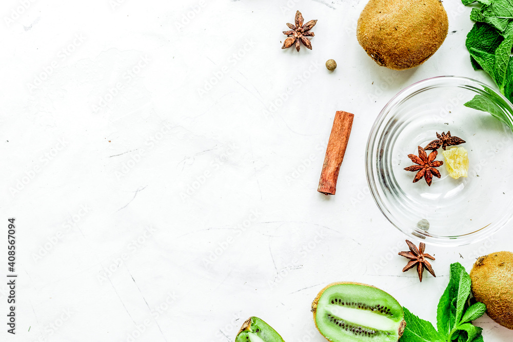 Skin care cosmetic with kiwi scrub on desk background top view mock-up