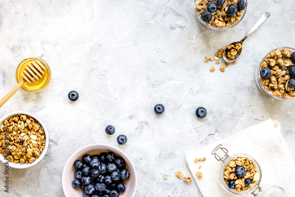 Oat flakes and berries granola glass on table background top view