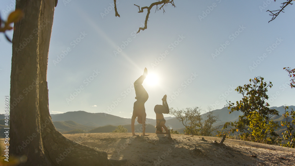 Couple yoga master practice yoga together on country side with background of beautiful landscape of 