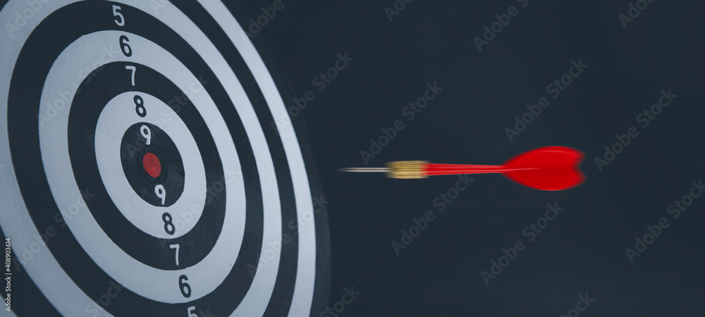 Close up shot of the dart arrow hit on bullseye, red dart arrow hitting in the target center of dart