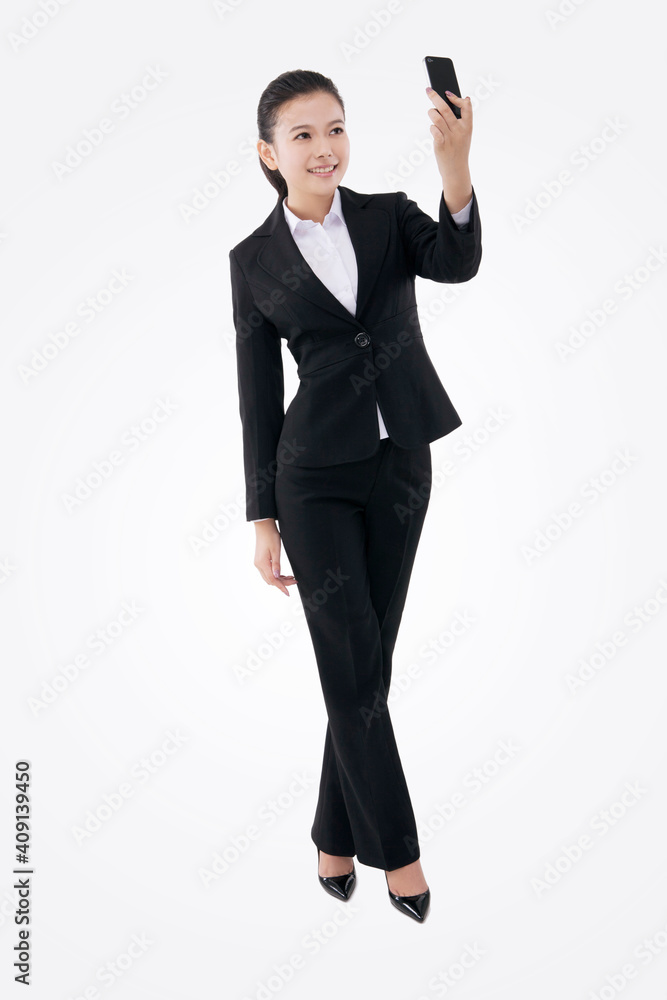 Oriental fashion business woman using mobile phone self-timer