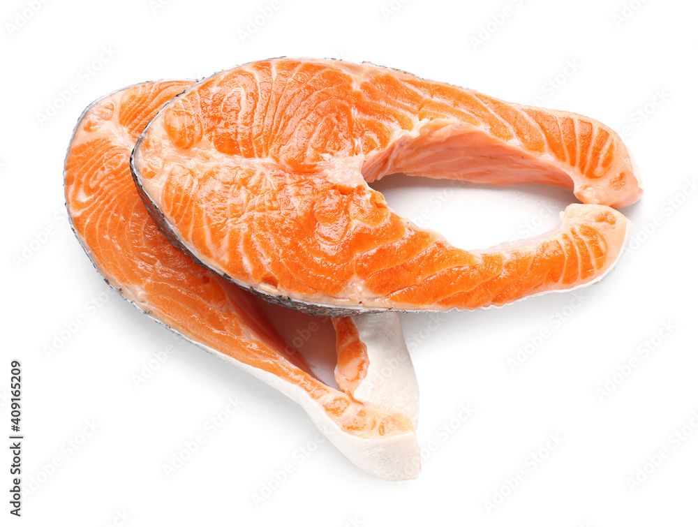 Raw salmon steaks on white background