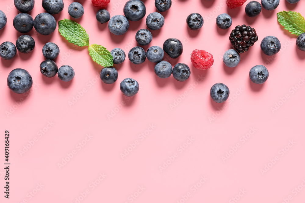 Different ripe berries on color background