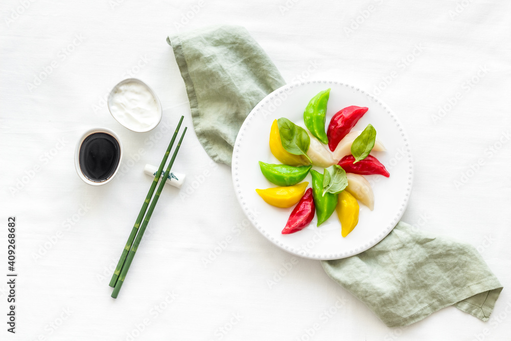 Homemade vegetables dumpling tortellini or ravioli on white plate, overhead view