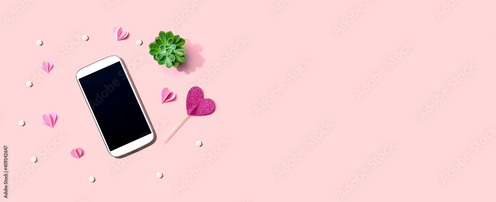 Smartphone with hearts and a succulent - flat lay