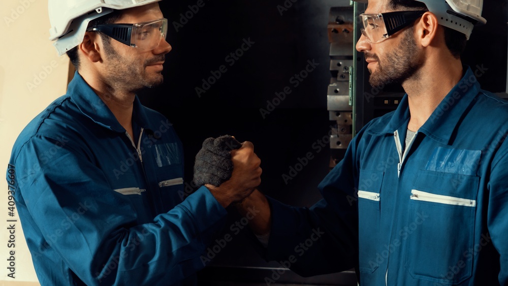 Two skillful factory engineer or worker showing teamwork and partnership . Industrial people and man