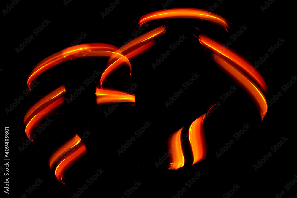 Light wave trail path, vibrant neon gold color in abstract swirls on a black background