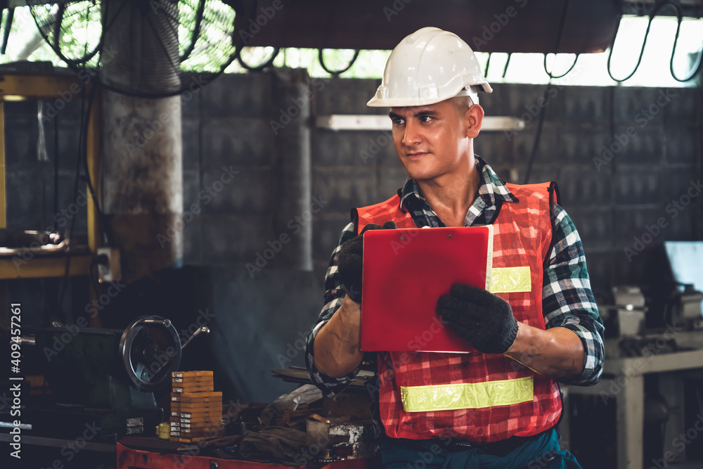 Manufacturing worker working with clipboard to do job procedure checklist . Factory production line 