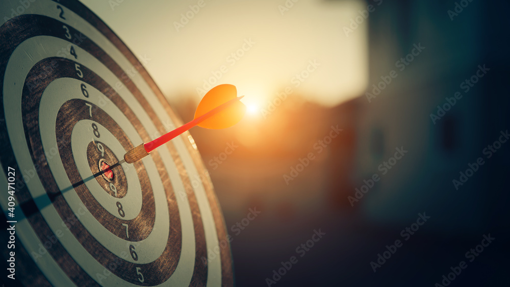 bullseye target or dart board has red dart arrow throw hitting the center of a shooting for business