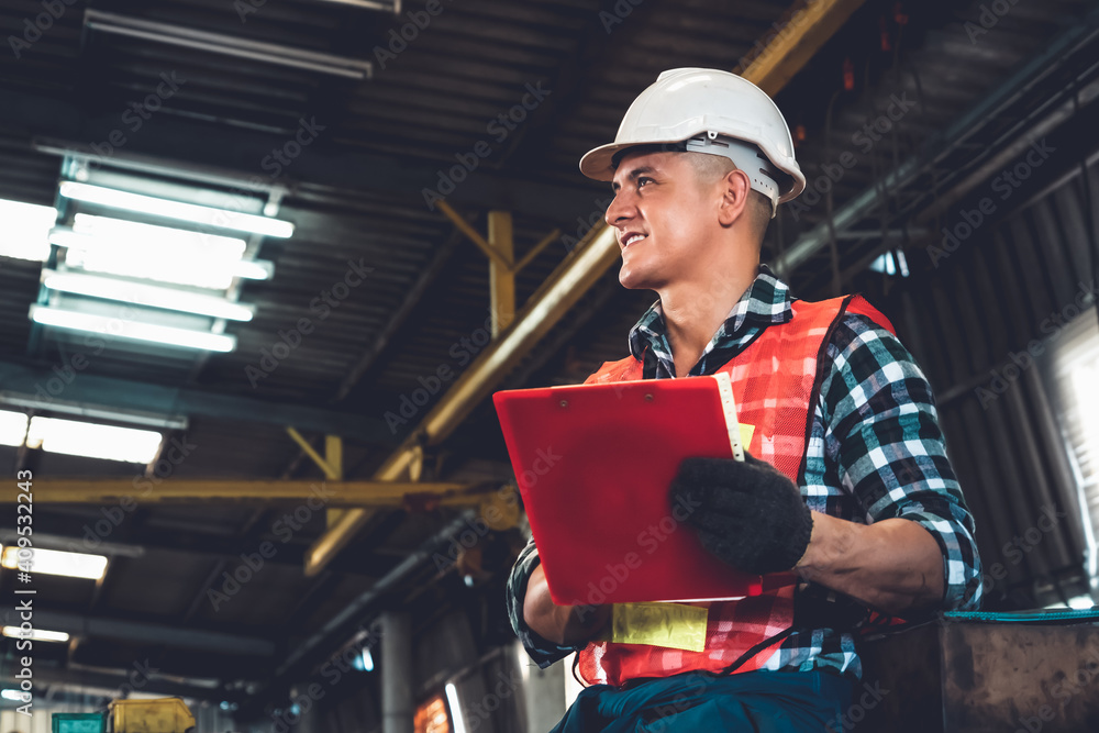 Manufacturing worker working with clipboard to do job procedure checklist . Factory production line 