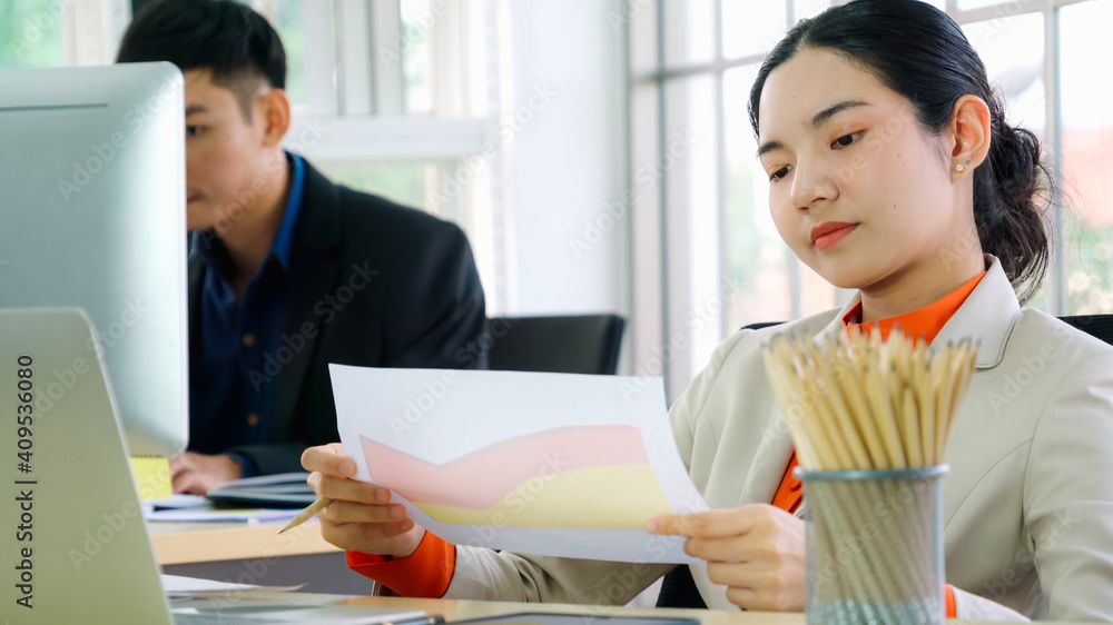 Business people working at table in modern office room while analyzing financial data report .