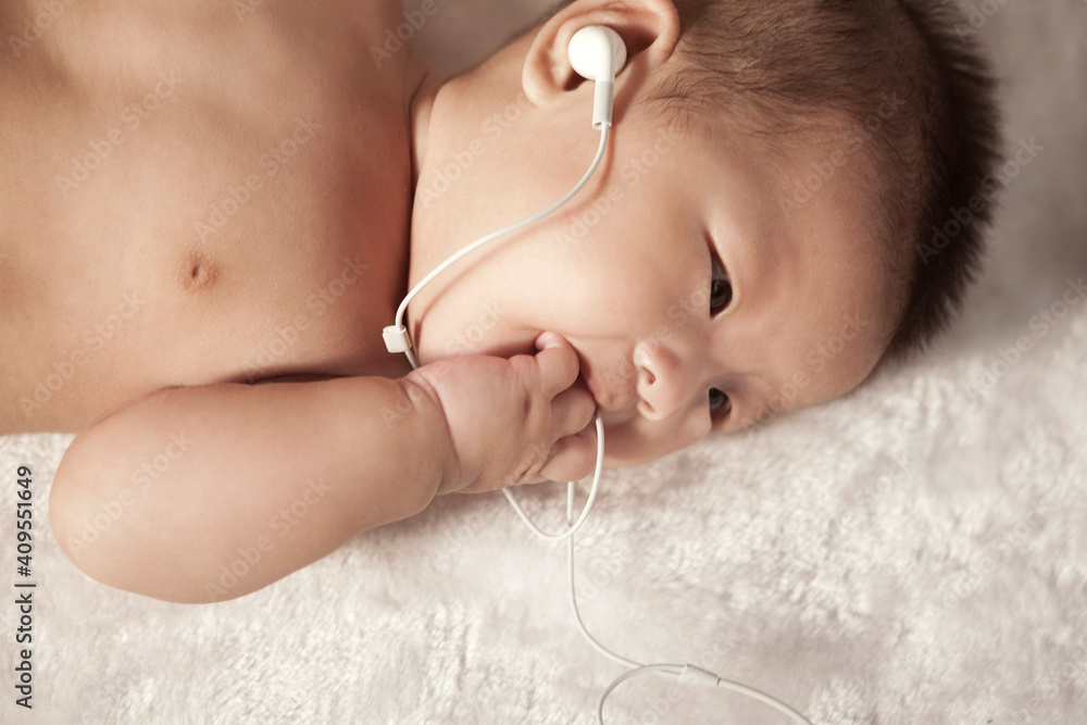 Baby with a earbud