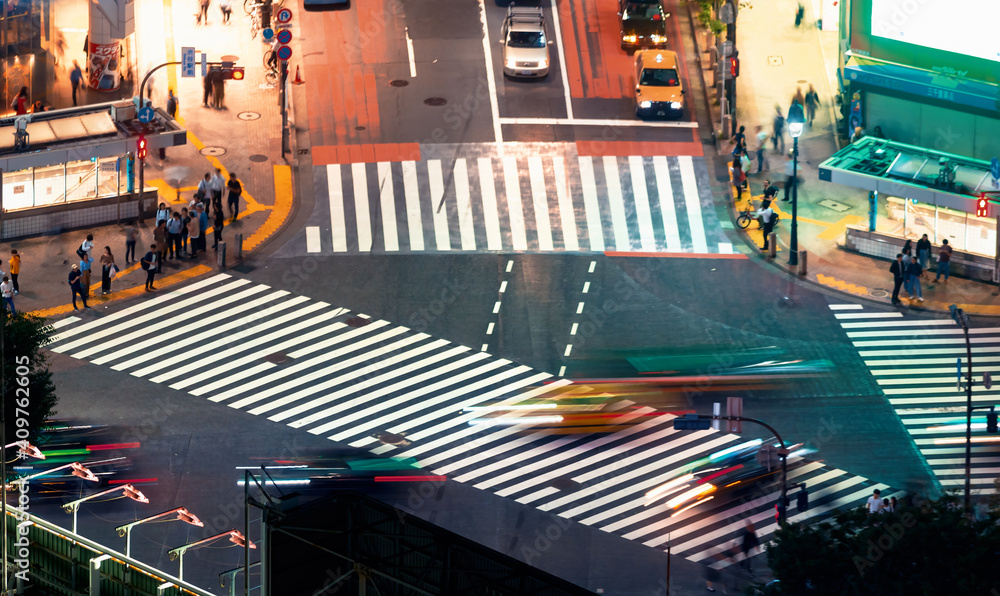 People and traffic cross the famous scramble intersection in Shibuya, Tokyo, Japan, one of the busie