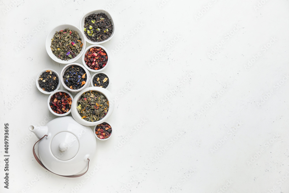 Composition with bowls of dry fruit tea on light background