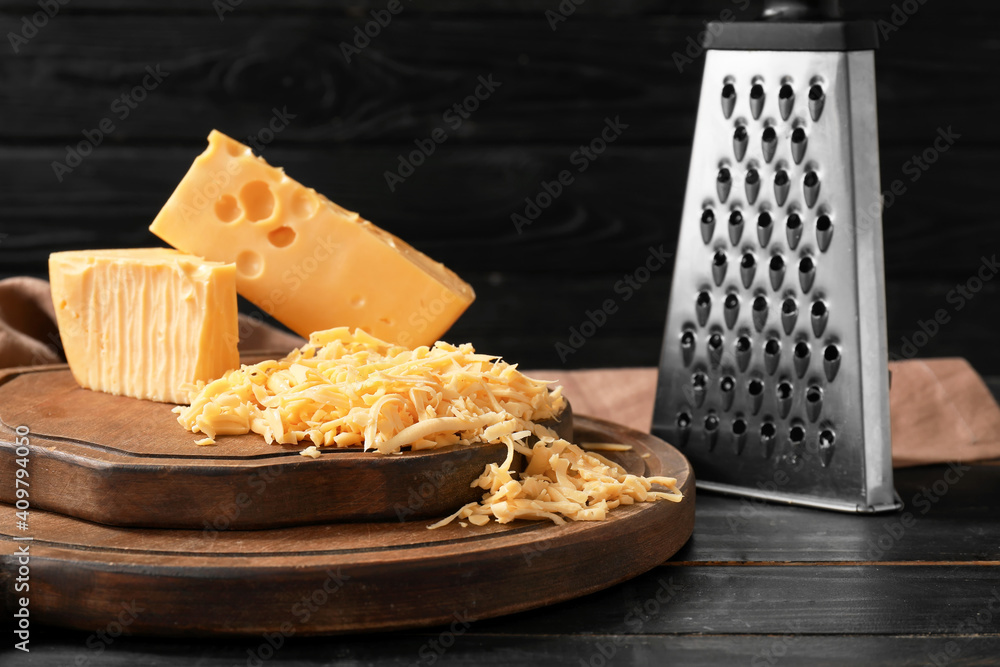 Tasty cheese on dark wooden background