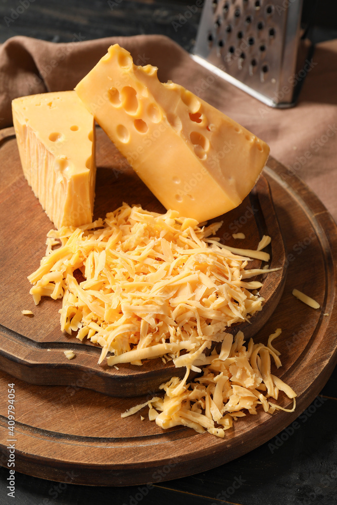 Tasty cheese on dark wooden background