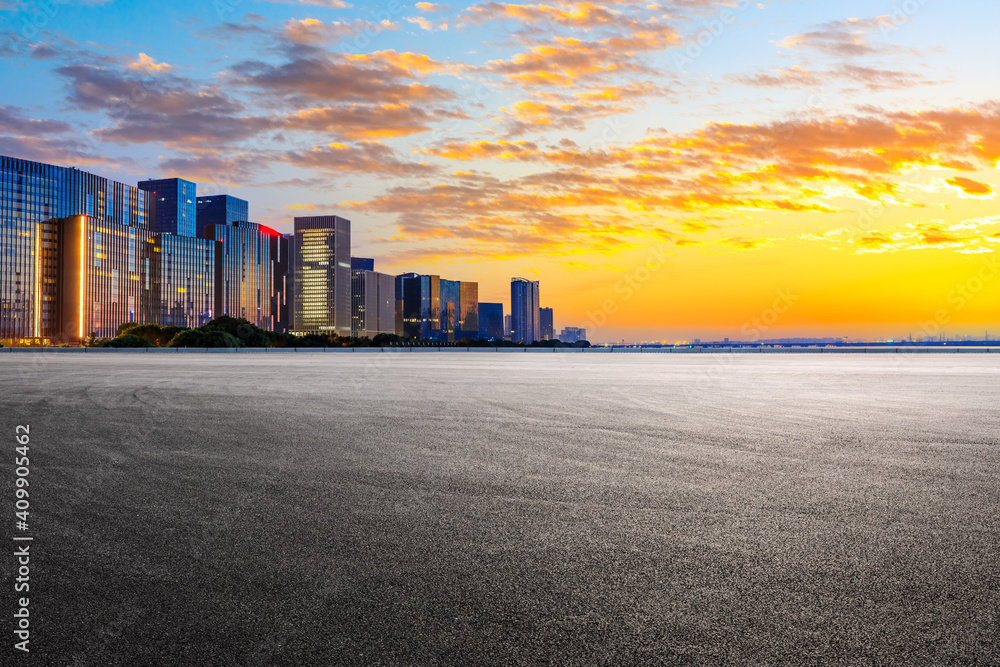 Race track road and Hangzhou skyline with buildings at sunrise.