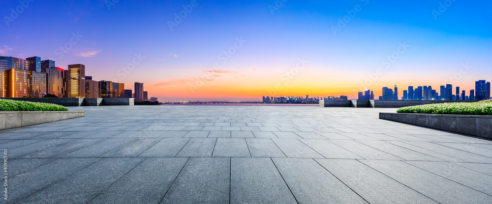 Empty square floor and modern city skyline in Hangzhou at sunrise,China.