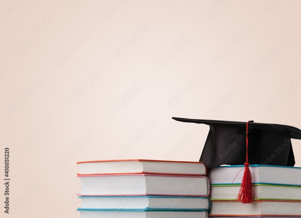 Graduation hat and stack of study books