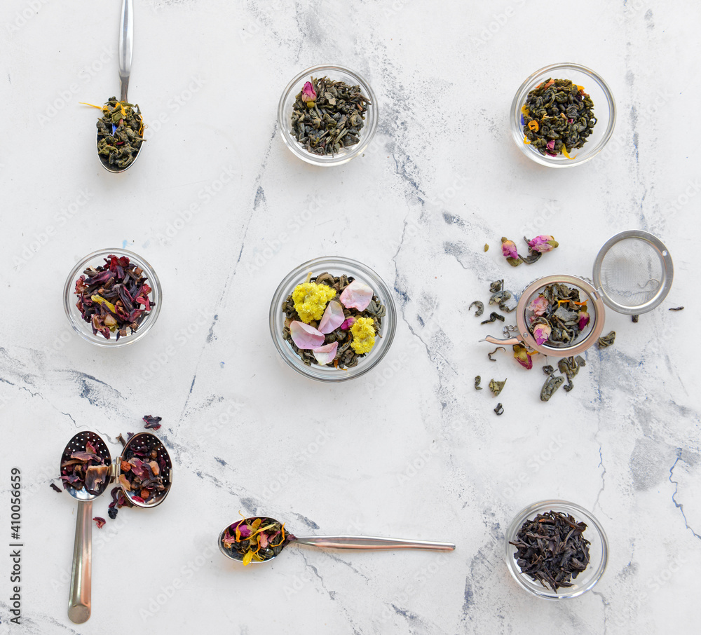 Composition with dry tea leaves and flowers on light background