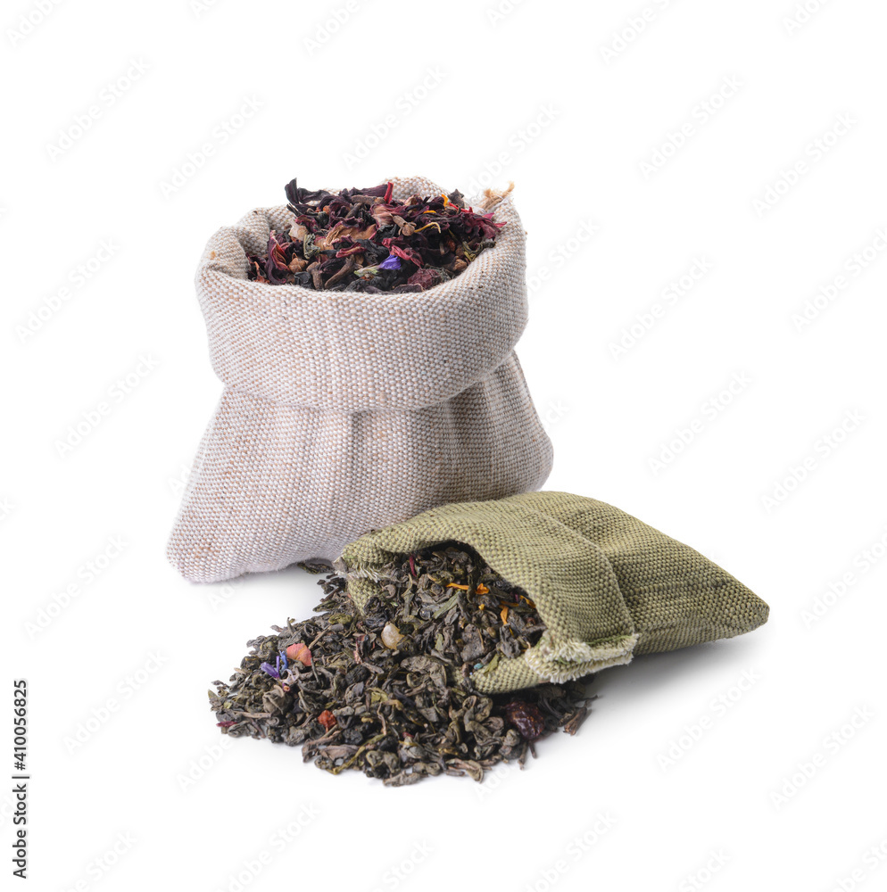 Bags with dry tea leaves on white background