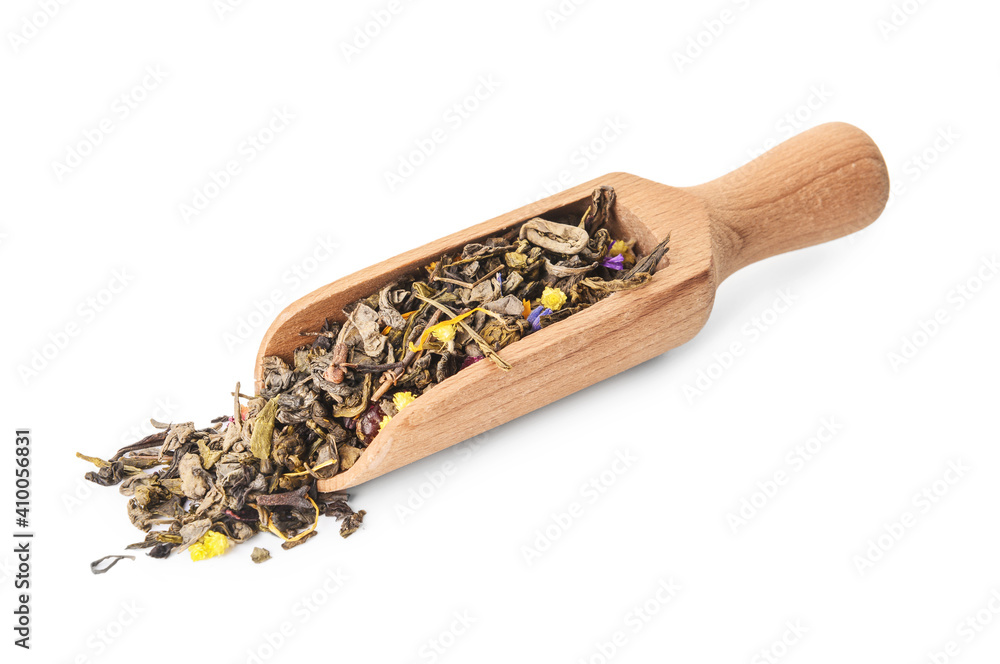 Wooden scoop with dry tea leaves on white background