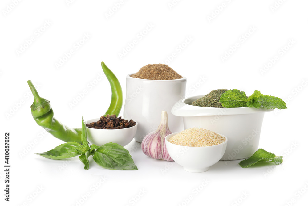 Bowls with different spices and herbs on white background