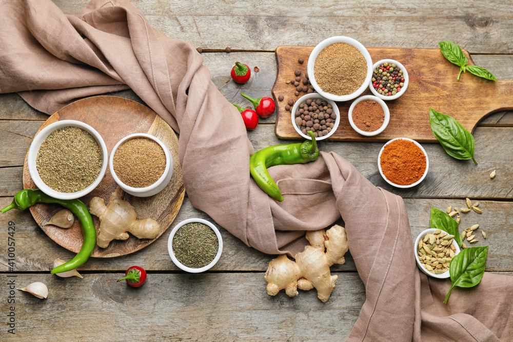 Composition with different spices on wooden background