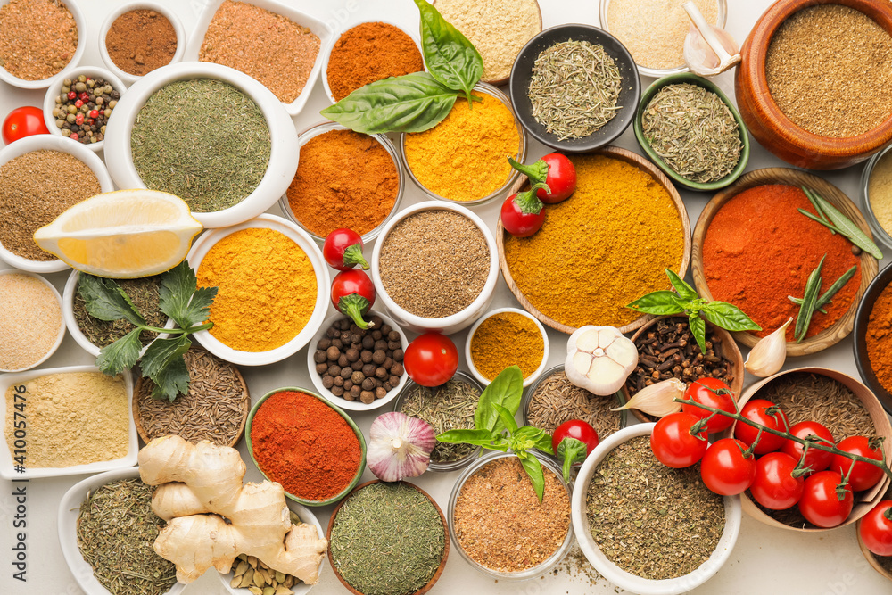 Composition with different spices and herbs on light background, closeup