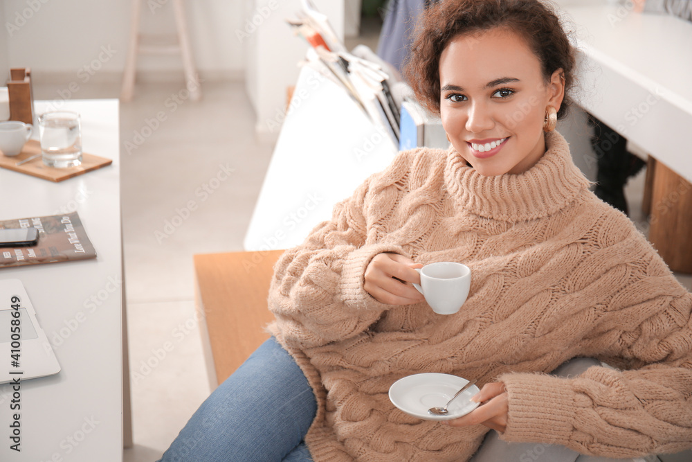 Beautiful woman drinking hot espresso in cafe