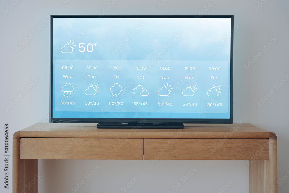 Smart TV with weather forecast on wooden stand