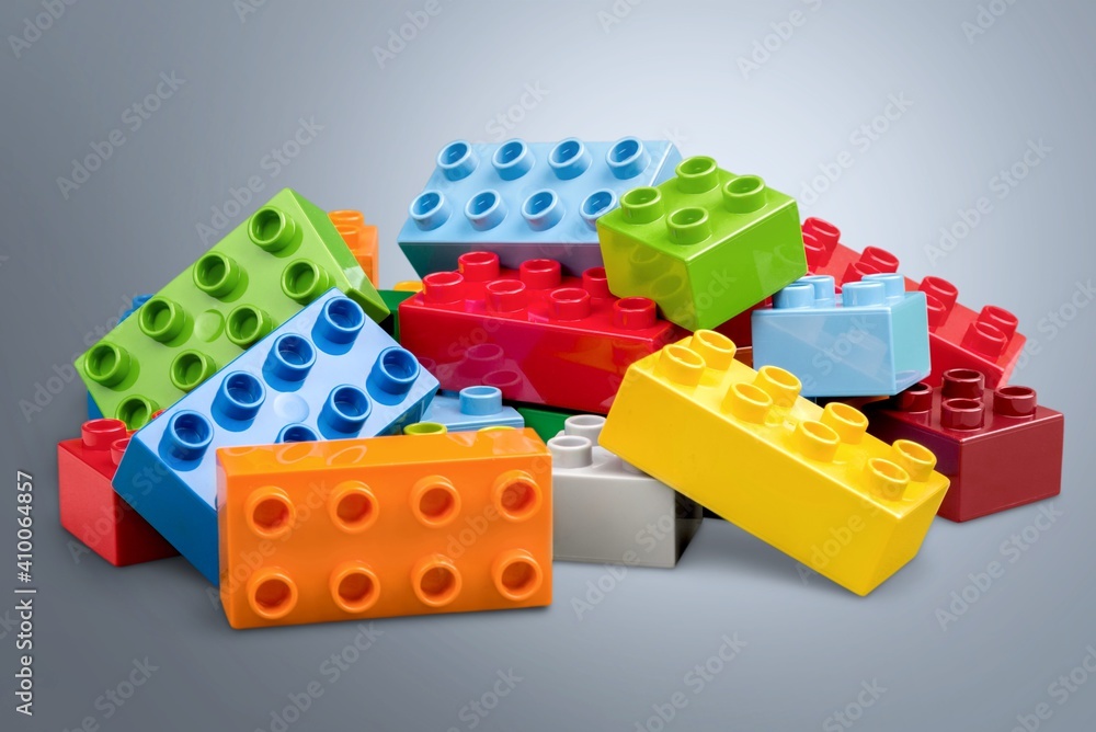 Colorful children building bricks on desk