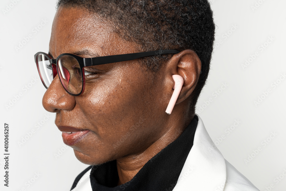 African American woman wearing wireless earbuds