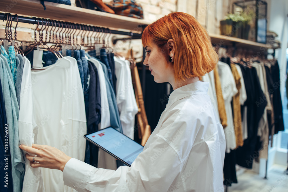 Woman taking inventory in clothing store