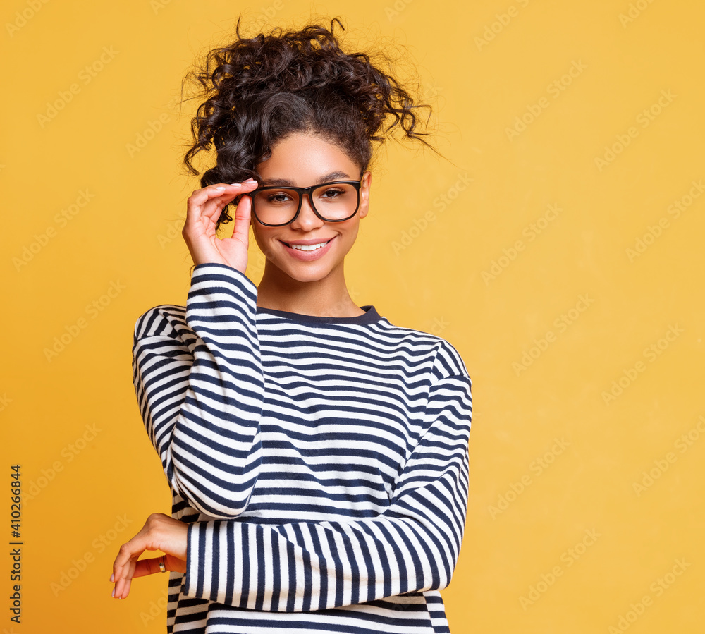 Smart ethnic woman adjusting glasses