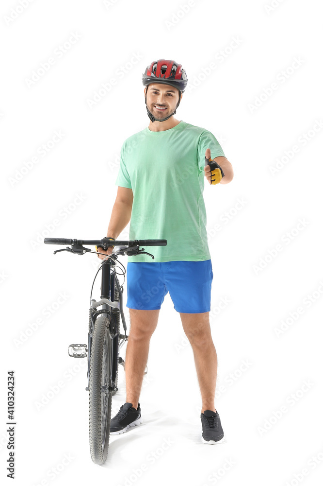 Male cyclist with bicycle showing thumb-up on white background