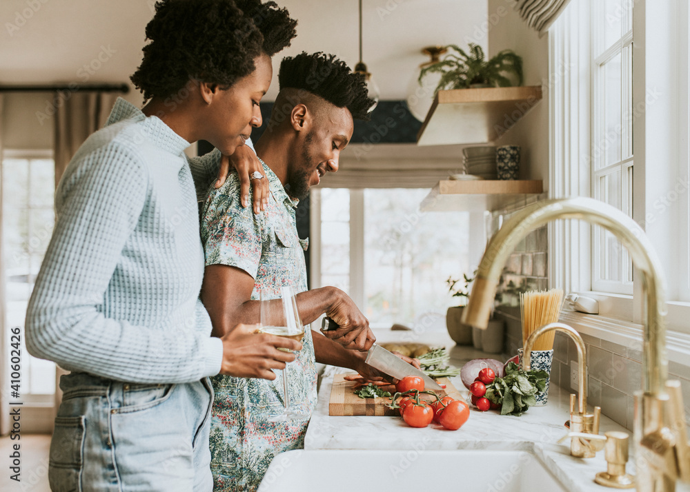 Black couple cooking in the kitchen