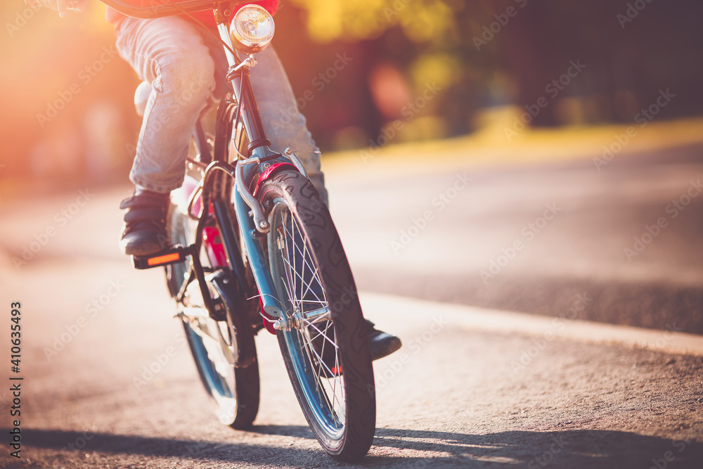 Child on a bicycle at asphalt road