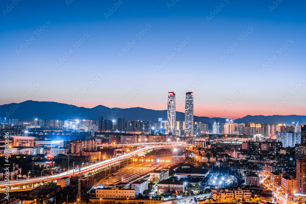 Night view of the twin towers, viaduct and railway station in Kunming, Yunnan, China 