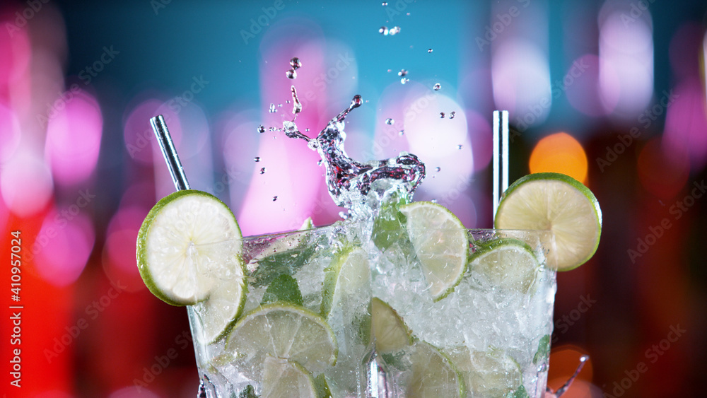 Closeup of two mojito drinks hitting each other in cheers gesture