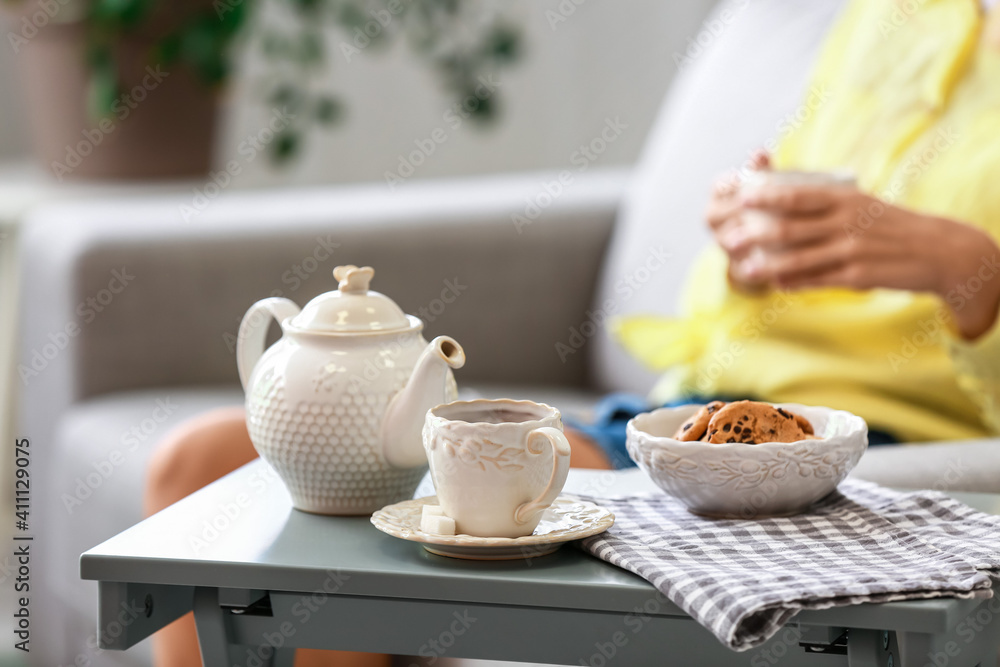 Teapot and cup on table in room