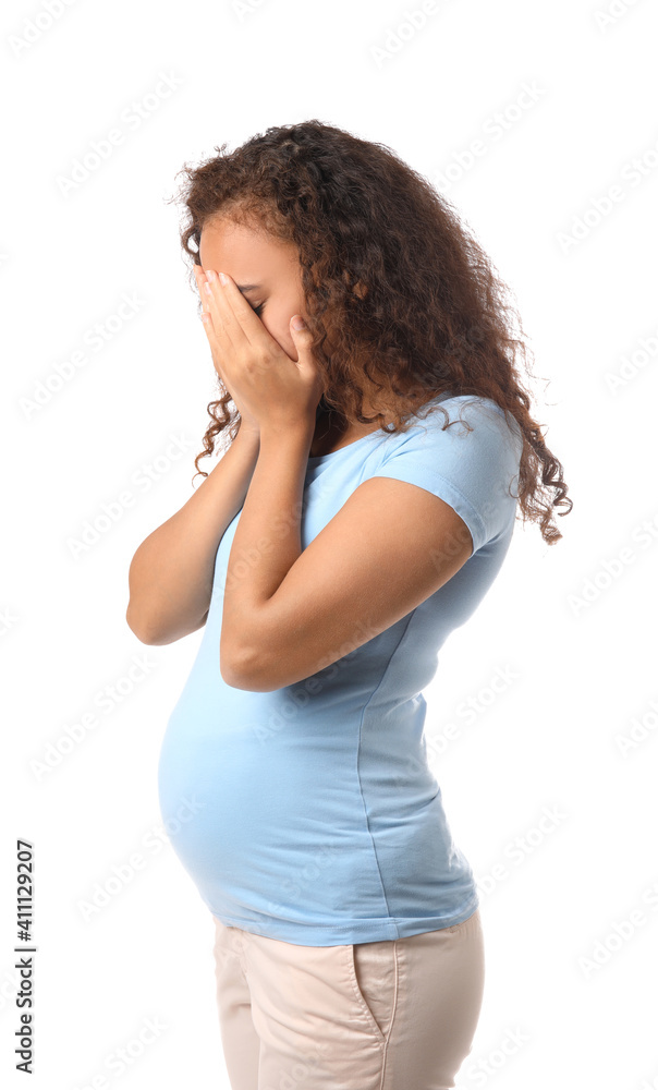 Stressed pregnant African-American woman on white background