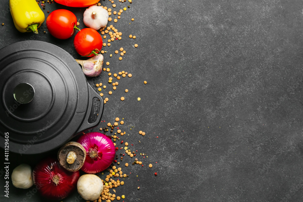 Vegetables and cooking pot on dark background