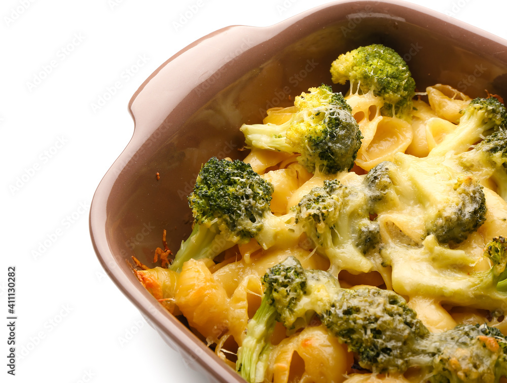 Tasty pasta in baking dish on white background, closeup