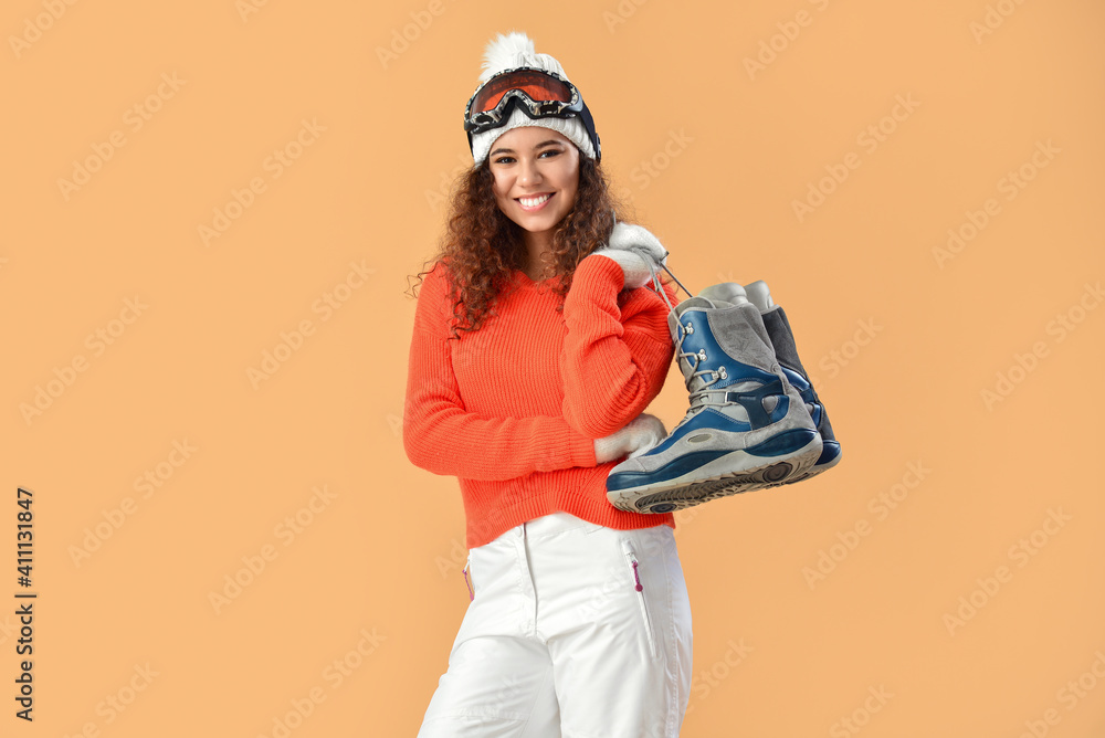 Female snowboarder on color background